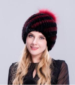 black leather hat with fur ball on top